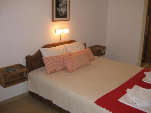 a bedroom with a bed with two pillows and a lamp at Villa ALEA in Dobra Voda