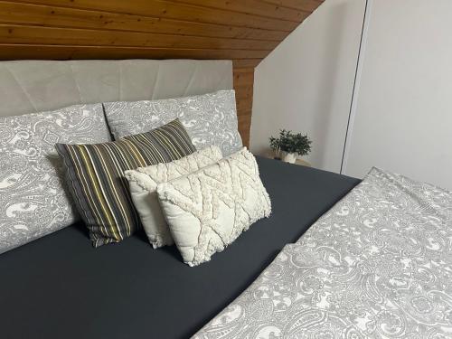 a bed with two pillows and a blanket at Blick auf den Rhein in Kestert
