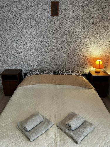 a bedroom with a bed with two pillows on it at Pokoje Gościnne Ontario Mieroszyno in Jastrzębia Góra