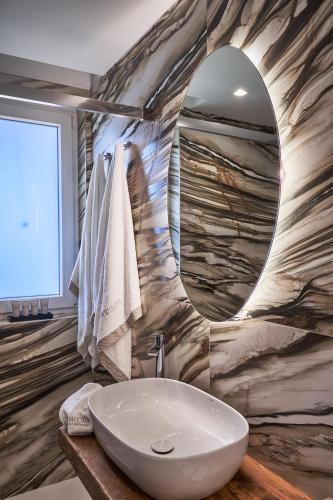 a bathroom with a sink and a mirror at THALORA - Luxury Apartments in Bari