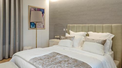 a bedroom with a large white bed with white pillows at Royal Fraga do Douro in Vila Real