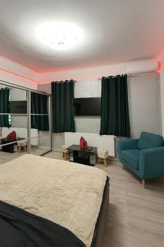 a bedroom with a bed and a blue couch at Apartament Salina Turda in Turda