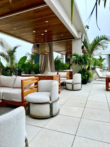 a patio with couches and chairs on a building at Moxy Miami Wynwood in Miami