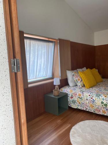 a bedroom with a bed and a window at Douro Wellspring in Santa Marinha do Zêzere