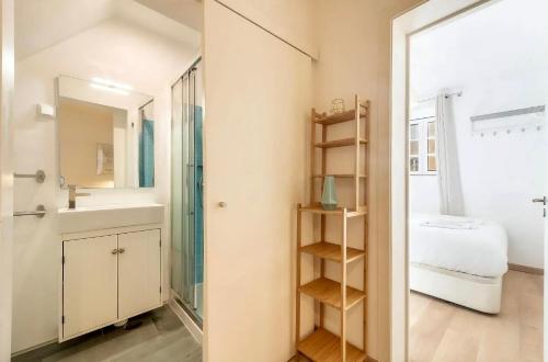 a bathroom with a sink and a mirror at Casa Alfama Apartment in Lisbon