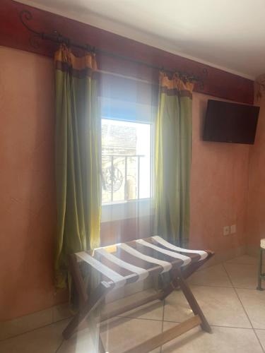 Télévision ou salle de divertissement dans l'établissement Hôtel CASITA