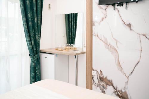 a bedroom with a mirror and a bed at Villa Champion in Ulcinj
