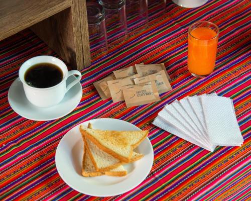 a plate of toast and a cup of coffee at Hotel Universo in Ayacucho
