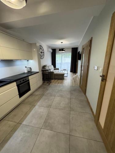 a kitchen and living room with a couch and a table at Apartament Jarosław in Jarosław