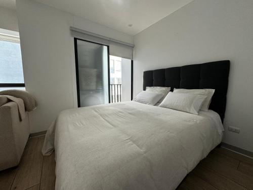 Postel nebo postele na pokoji v ubytování Hermoso Depa Monoambiente en Magdalena cerca a san isidro