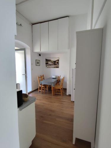 a kitchen and dining room with a table and chairs at Kolbe Hvar Piazza Apartment in Hvar