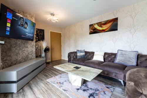 a living room with a couch and a table at FIve Star Rated Condo in Manchester