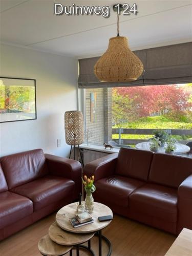 a living room with a couch and a table at Appartementen Zuiderstrand H in Westkapelle