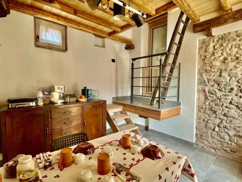 a kitchen with a table and a ladder in a room at BnB Tana del Gufo in Abbadia Lariana