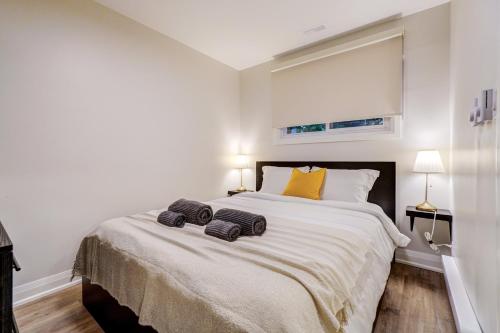 a bedroom with a large bed with two towels on it at Adrian's Suites 1 Bedroom Junior Suite in Wasaga Beach