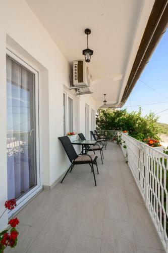 a patio with chairs and a table on a balcony at Harmony Point in Bar