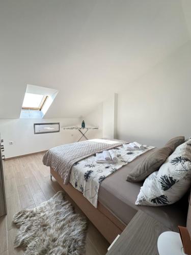 a bedroom with a bed with a window and a rug at Apartman Maky in Biograd na Moru