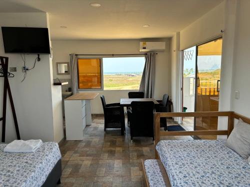 a room with two beds and a kitchen with a table at Casa Bita Morales CASA 201 in Cartagena de Indias