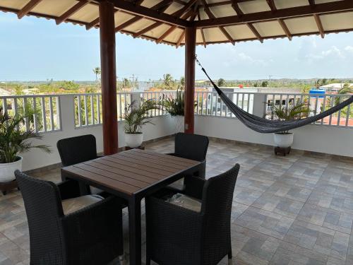 a porch with a hammock and a table and chairs at Casa Bita Morales CASA 201 in Cartagena de Indias