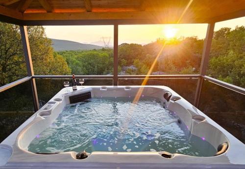 a jacuzzi tub on the balcony of a house at Holiday house Villa Sena , Lovreć, Makarska in Opanci