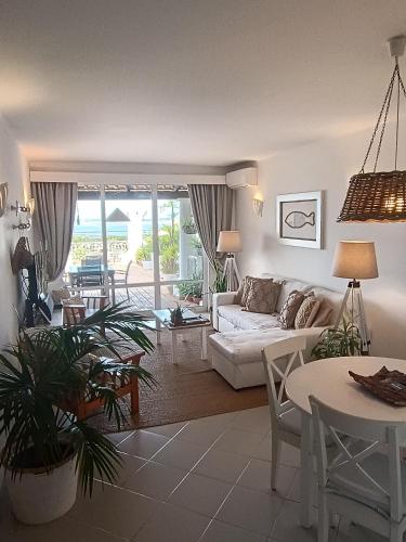 a living room with a white couch and a table at Ocean Terraces Vila Gaivota I in Ferragudo