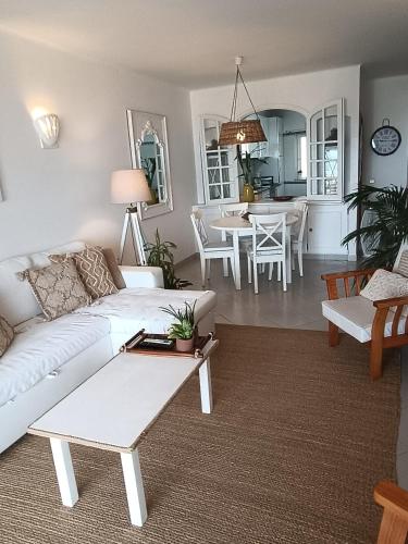 a living room with a white couch and a table at Ocean Terraces Vila Gaivota I in Ferragudo