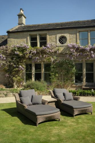 two couches on a lawn in front of a house at Outwood House in Horsforth