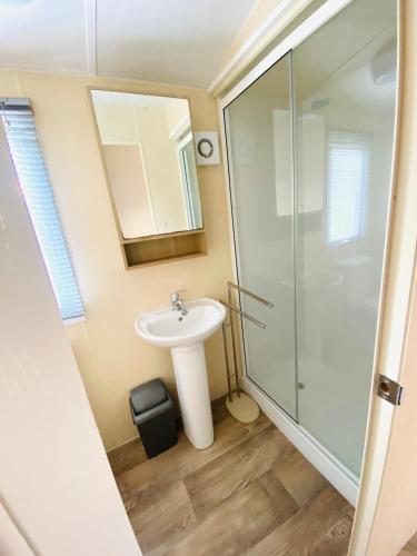 a bathroom with a sink and a shower at Calm View in St Austell