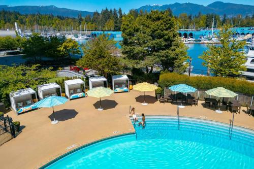 an overhead view of a pool with umbrellas and a marina at The Westin Bayshore, Vancouver in Vancouver