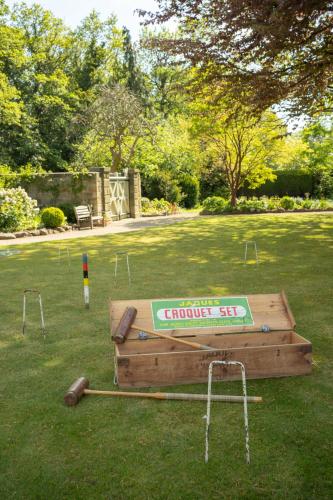 a wooden game table in a grassy field at Outwood House in Horsforth