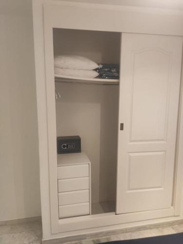 a closet with a door with a clock in it at Hidalgos SolyGolf in Manilva