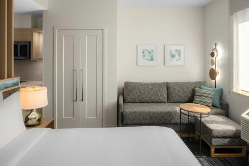 a living room with a bed and a couch at TownePlace Suites by Marriott San Jose Downtown in San Jose