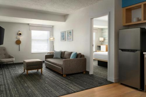 a living room with a couch and a bed at TownePlace Suites by Marriott Lafayette in Lafayette