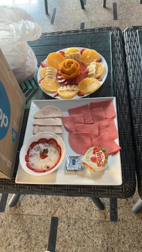 a table with two trays of different types of food at Hamza pyramids View in Cairo