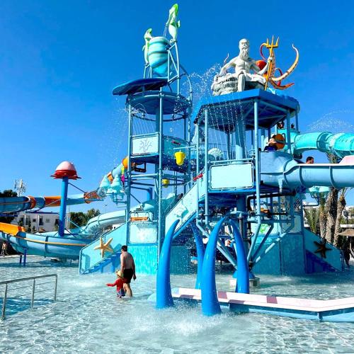 a water park with a water slide in the water at Holidays in Sousse Monastir 31 in Monastir
