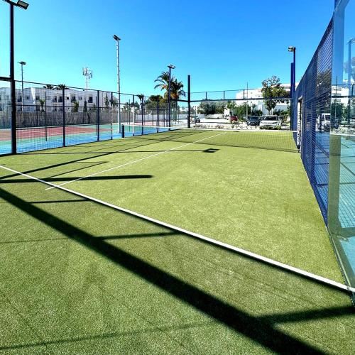 a tennis court with a net on a tennis court at Holidays in Sousse Monastir 31 in Monastir