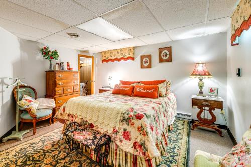 a bedroom with a bed and a dresser and a chair at 2 Mi to Walden Galleria Apartment with Patio in Buffalo