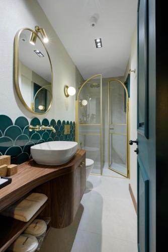 a bathroom with a sink and a mirror at Tinspiro Alaçatı in Alaçatı