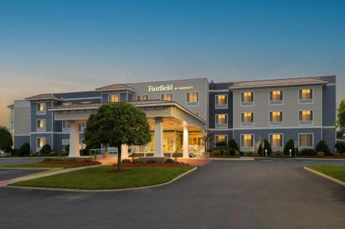 a large hospital building with a tree in the driveway at Fairfield Inn & Suites by Marriott Chincoteague Island Waterfront in Chincoteague