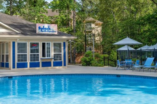 a swimming pool in front of a house at Marriott's Manor Club at Ford's Colony in Williamsburg