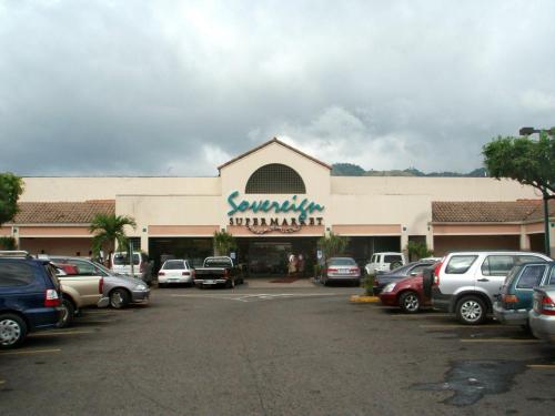 a shopping center with cars parked in a parking lot at Pearl of The City BEACH PEARL in Kingston