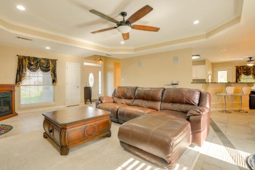 a living room with a couch and a ceiling fan at 9 Mi to Lake Texoma Calera Escape with Gazebo! in Calera