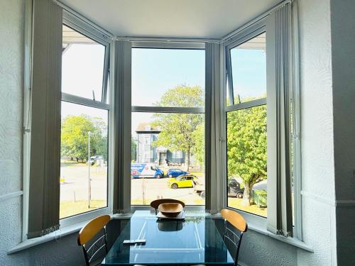 a table with chairs in front of a large window at Springfield Holiday Apartments HALodge Hotel in Skegness