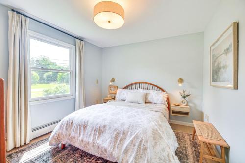 a bedroom with a bed and a large window at Family Getaway with Deck 3 Mi to Lake Champlain in Colchester