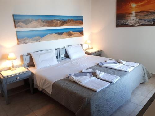 a bedroom with a bed with two towels on it at Villa Irena in Agalianós
