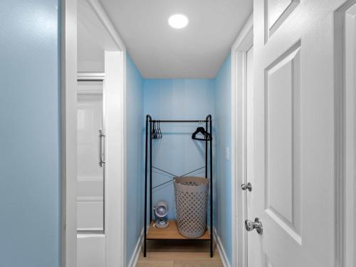 a hallway with blue walls and a white door at Riverfront Condo w Water Views-Heated Pool in Port Charlotte