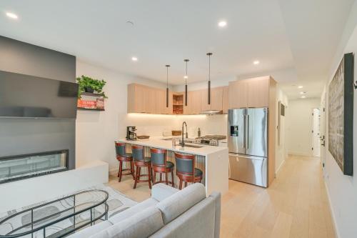 a kitchen and living room with a couch and a refrigerator at Near Biotechs and MIT Cozy Condo with Fireplace in Cambridge