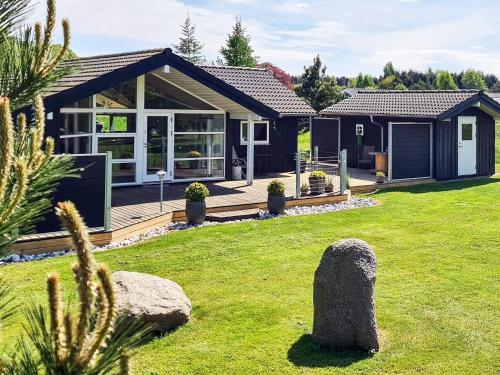 a house with a large yard with a house at Stylish Beach House - By Traum Ferienwohnungen in Nordborg