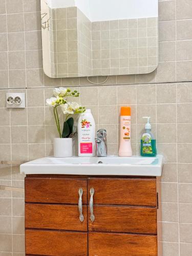 a bathroom sink with toiletries on top of it at Peaceful and Spacious Apartment at Luanda Bay in Luanda