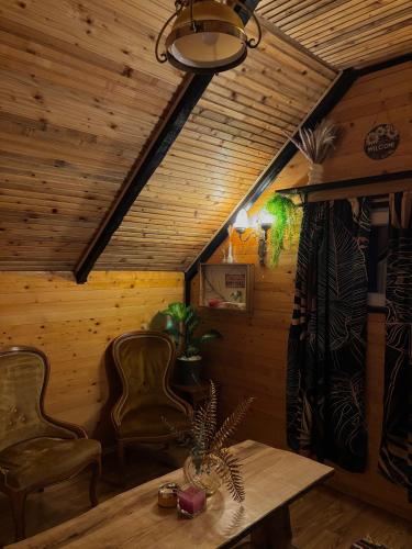 a room with a table and two chairs and a ceiling at Vikendica Euforija in Bijelo Polje